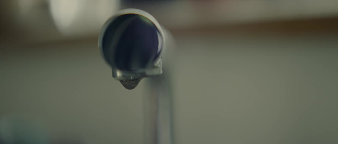 Water drops dripping from a pipe leak