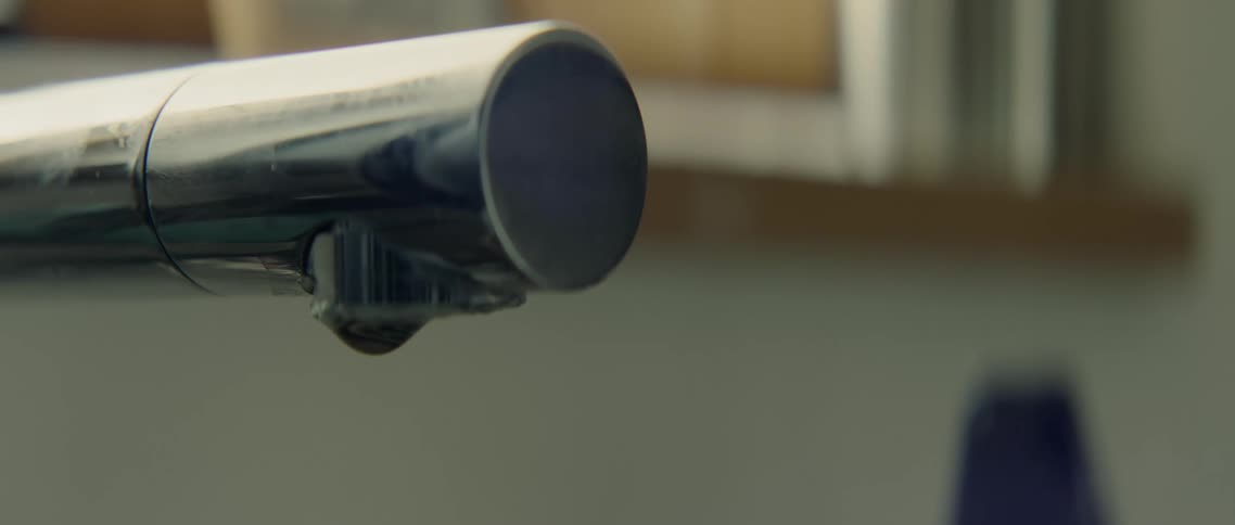 Water drips out of a faucet