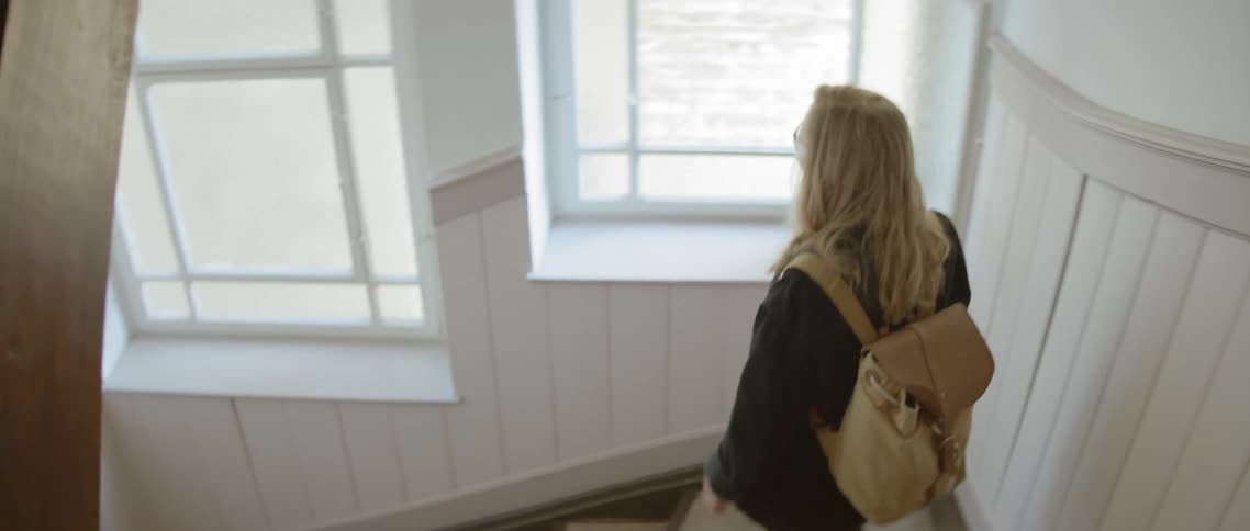 A woman walks down the stairs