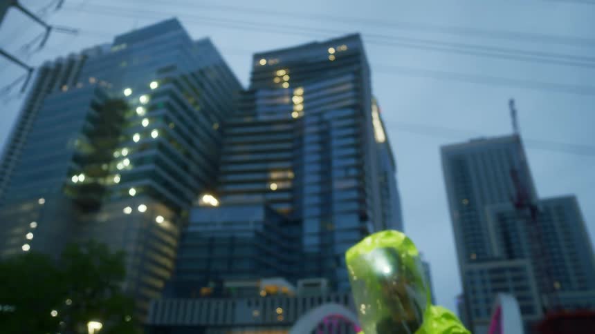 A man in protective gear looks around a downtown area
