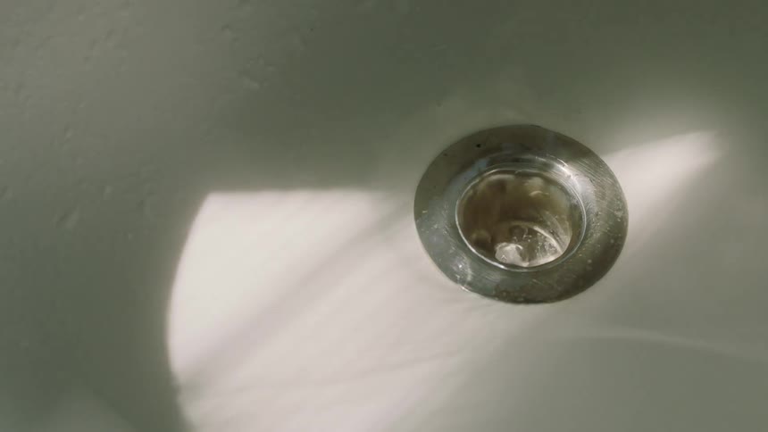 Water runs down a shower drain