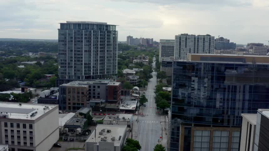 An aerial view of a downtown city is displayed
