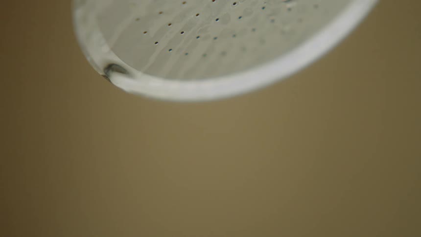 Water droplets are falling from the faucet