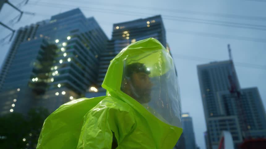 A man in full protective gear looks around him