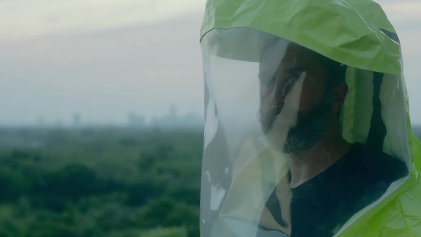 A man wearing protective gear looks around