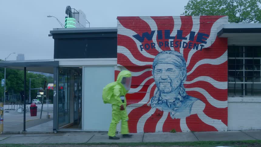 A man in protective gear walks down a city street