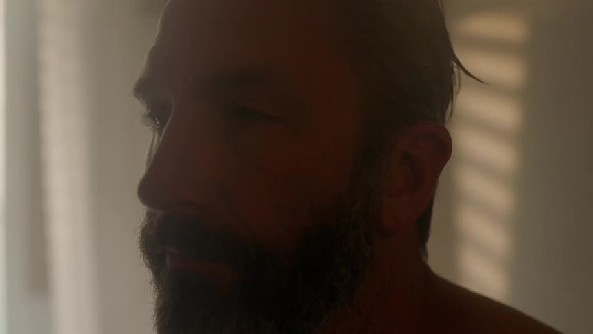 A man is in the room blinking