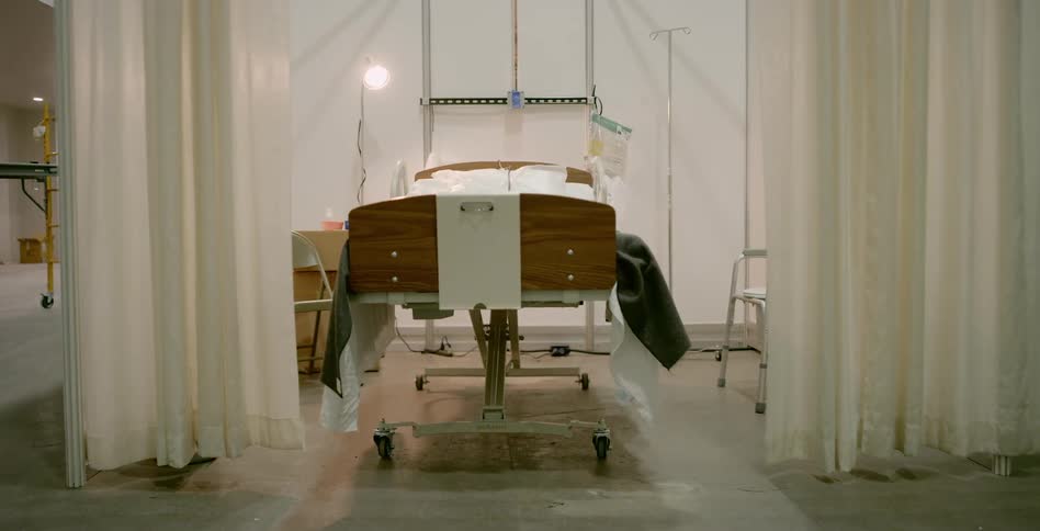 A hospital bed in an empty room
