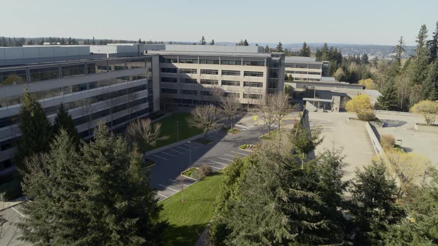 Aerial view of office building parking lot and garage