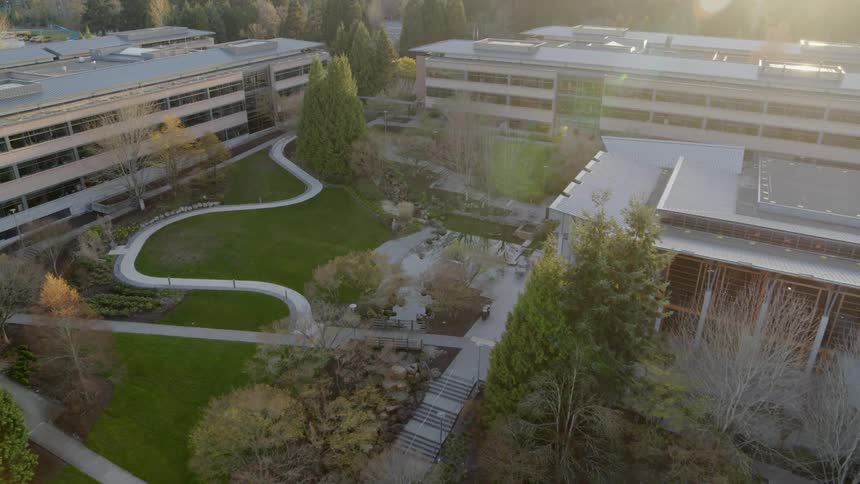 Flying above an office park courtyard at sunset