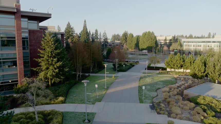Flying above landscaped campus grounds on a sunny day