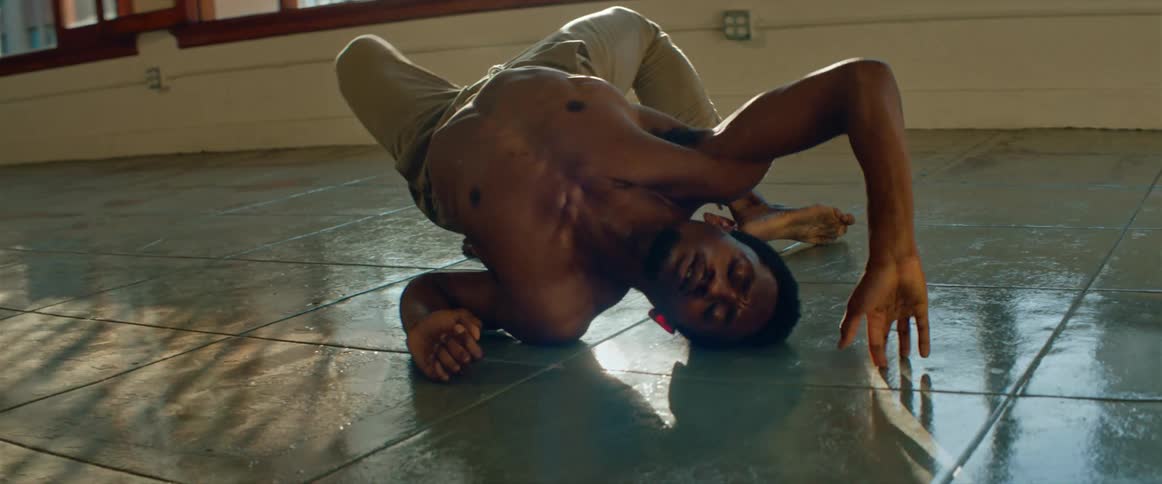A man is doing dance moves on a floor mat