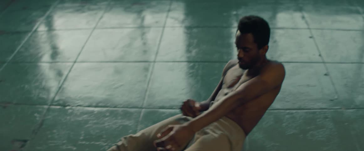 A man holds on to the wall and then falls to the ground