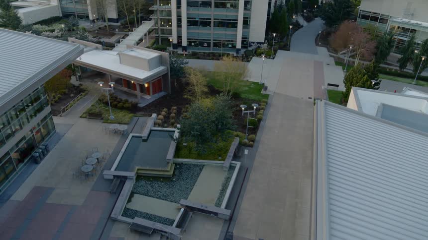 Empty walkways and seating areas of a landscaped campus