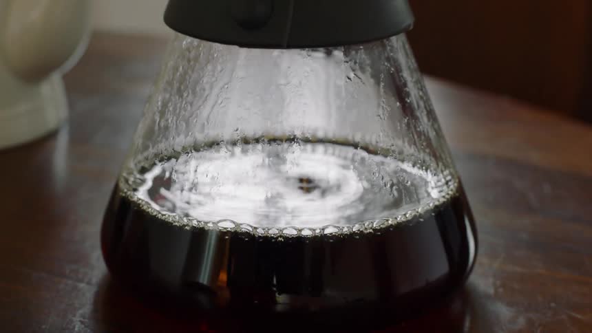 Coffee drinking through a filter into a glass coffee pot