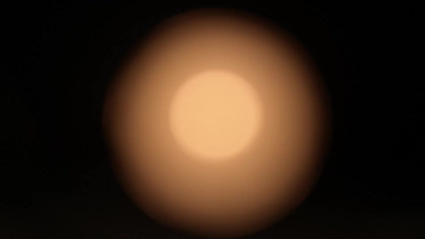 Aperture turns shows are slightly orange ball against black background