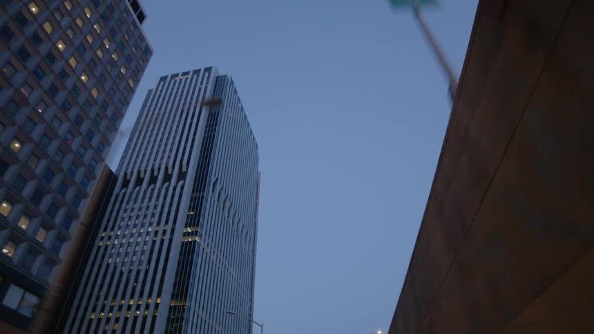 The tall buildings are lit at sunset