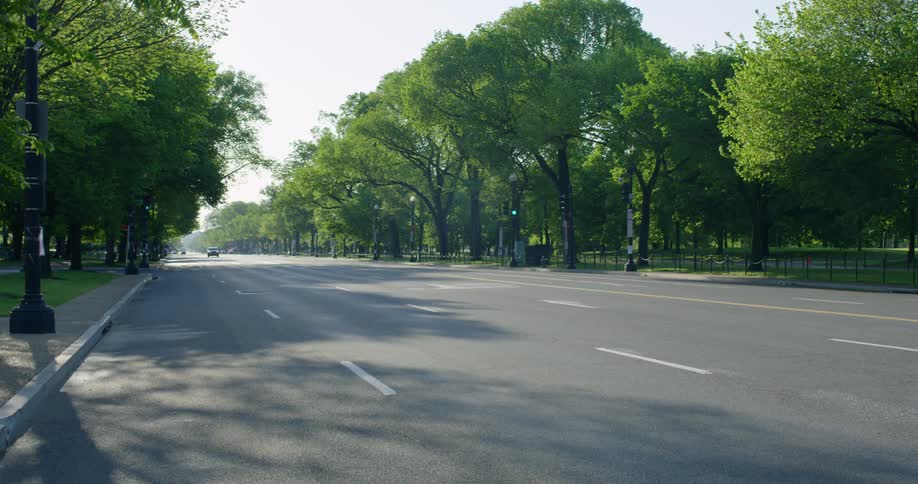 Cars travel together on the nearly empty street