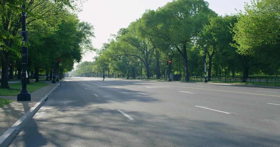 A person out running crosses the street