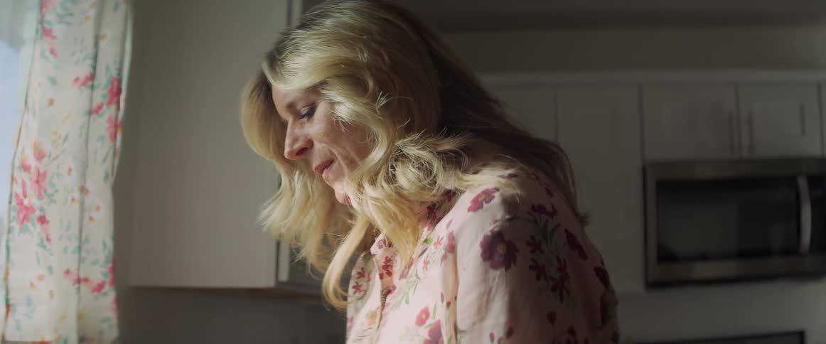 A woman is standing in a kitchen