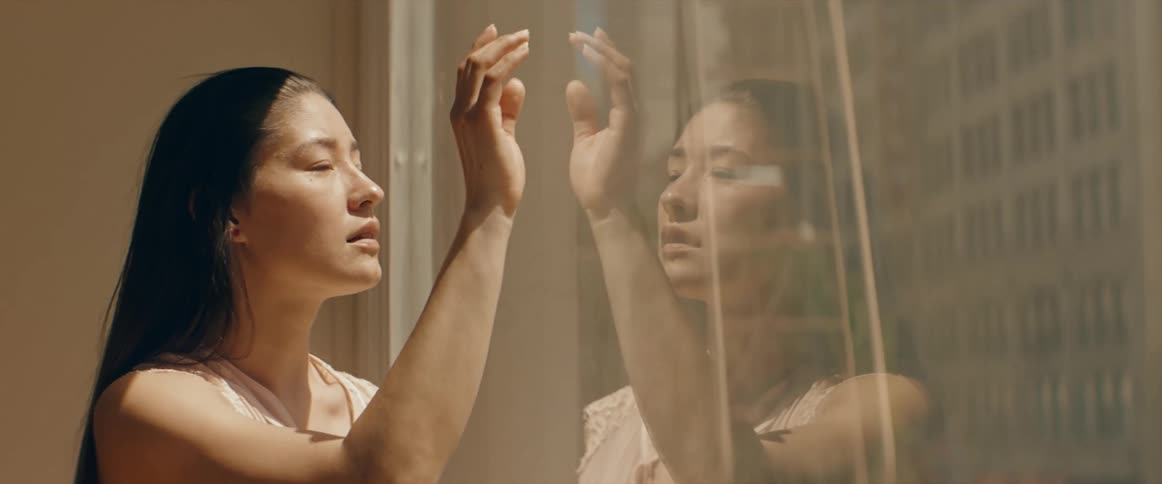 A woman touches the window
