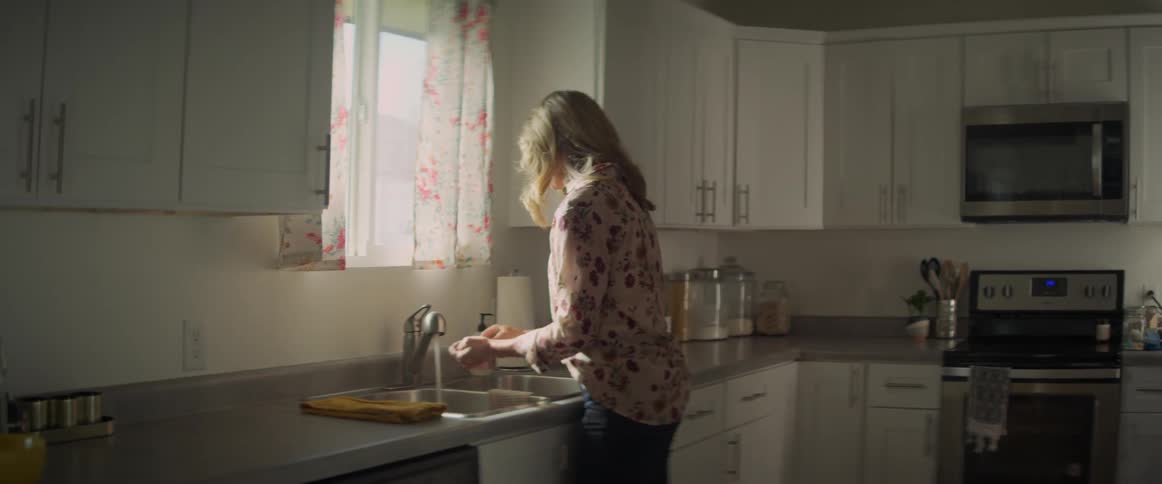 A woman washes her hands