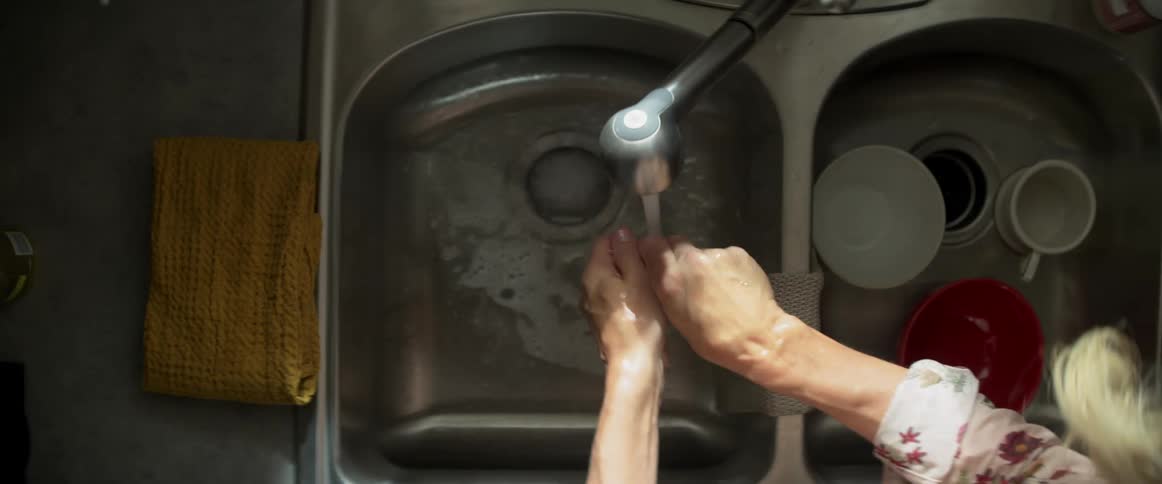 A woman washes her hands