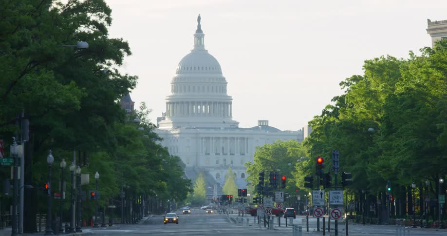 The vehicles travel near the capitol building in Washington DC