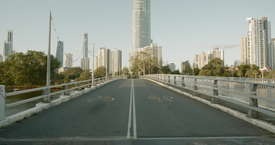 An empty bridge with the city skyline in the distance
