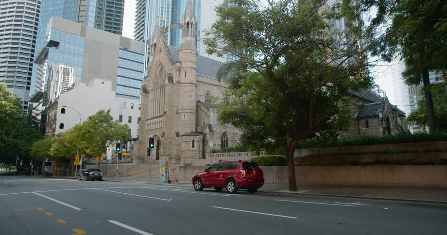 A church with buildings and skyscrapers in the background