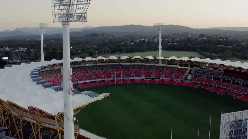 An empty circular sports stadium in the evening