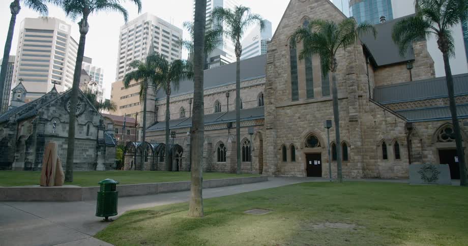 A church with buildings and skyscrapers in the background