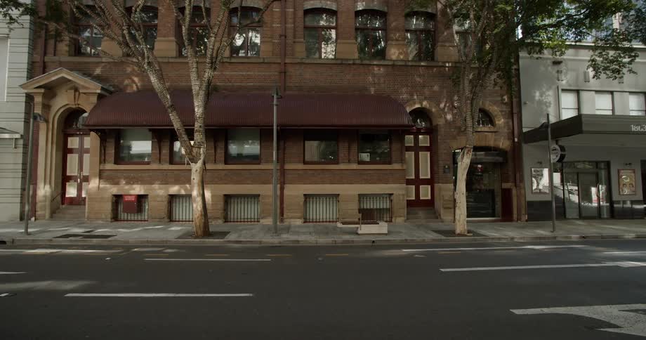 Street and sidewalk remain empty outside stores with awnings