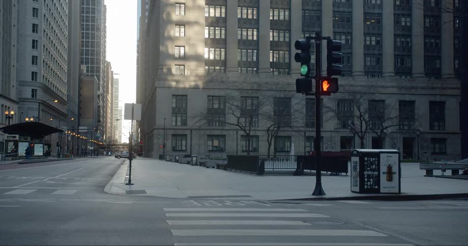 A car drives down a quiet city street