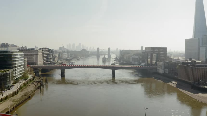 Aerial view of small bridges over the city river with the city skyline in the background