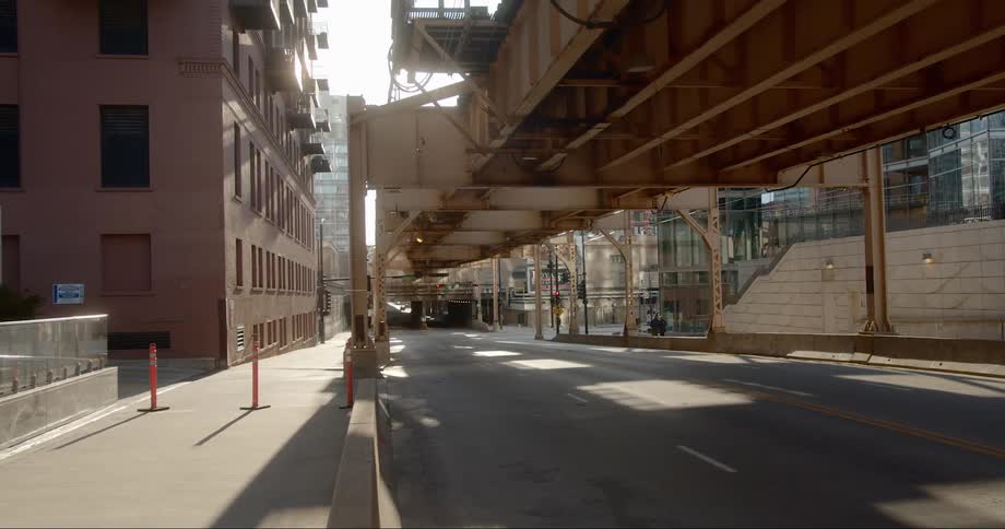 The avenue under the overpass is empty in the city