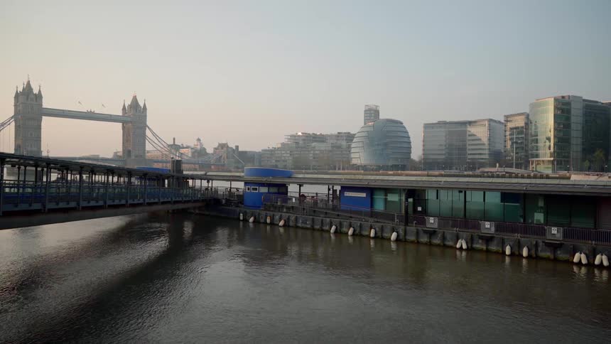 A river with a bridge and buildings in the background