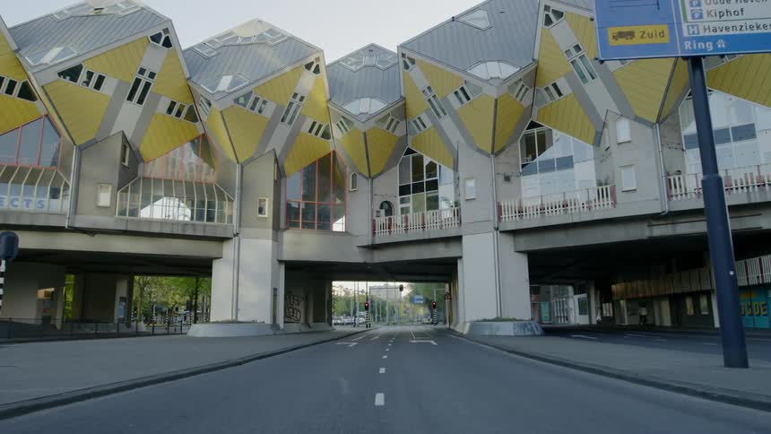 An elaborately designed building over a road in a city