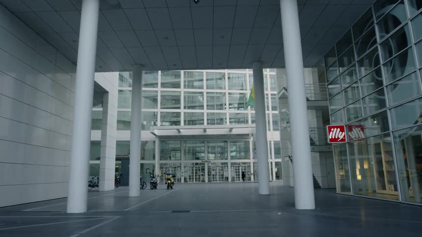 Lone person walking through deserted outdoor shopping mall