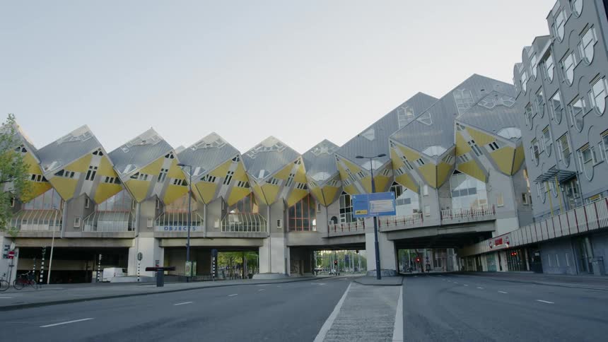 A large building built on a bridge over a wide city street