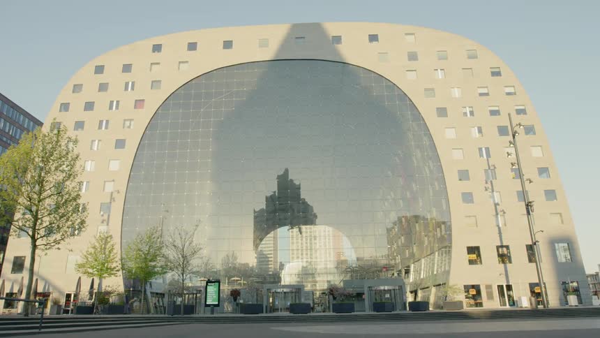 Short steps lead to an arched building with a large arched window in the center