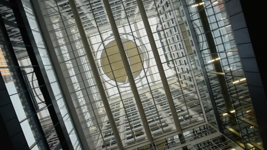 A spherical art installation sits between skyscrapers and is visible from below