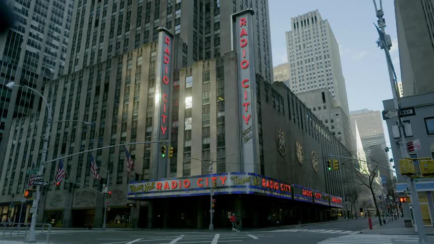 People walk past an empty intersection in new york city
