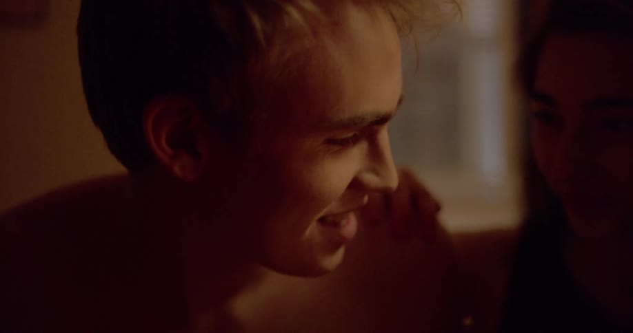 A boy and girl look at each other in the room