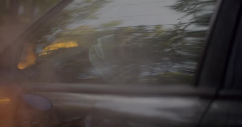 Person can be barely seen in burning car with dented drivers door
