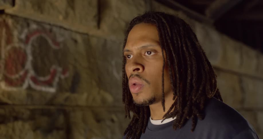 Man walking under tunnel stop to look forward cautiously