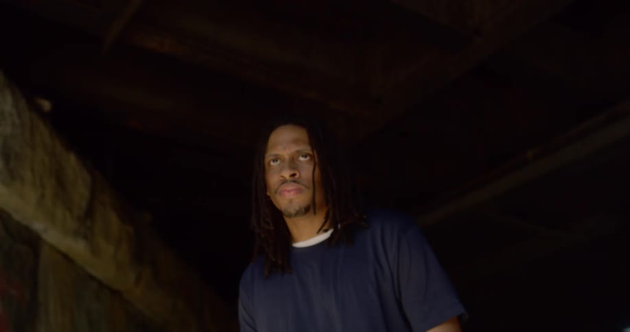 A man looks fearful under the overpass
