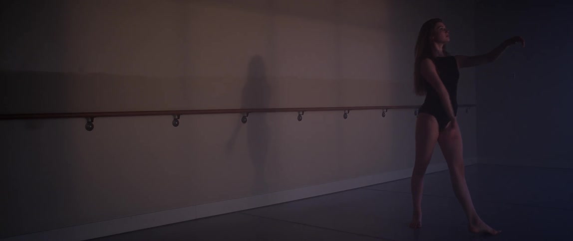 A woman in black dances slowly