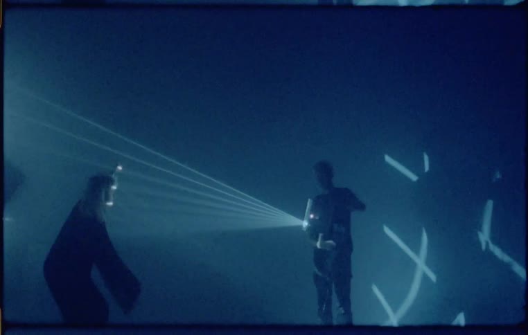 Two people perform with a light show