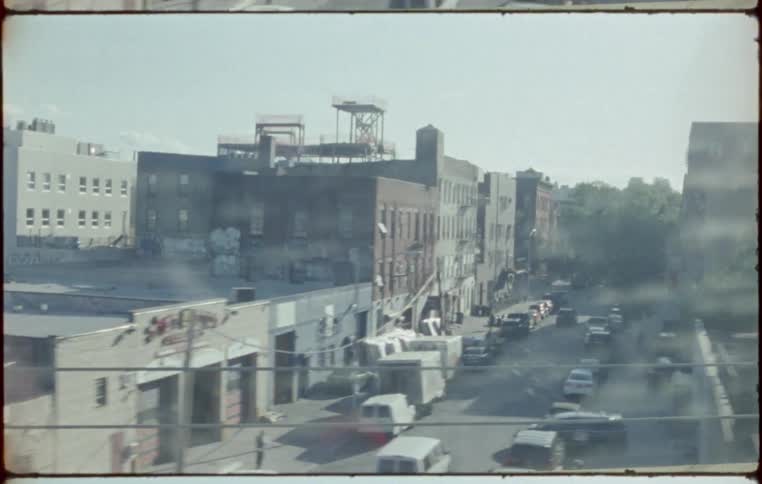 A city with streets and buildings and a train platform
